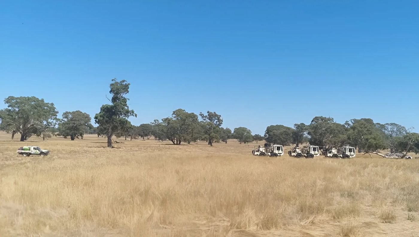 Survey vehicles in a dry agricultural paddock, Otway Basin, South Australia